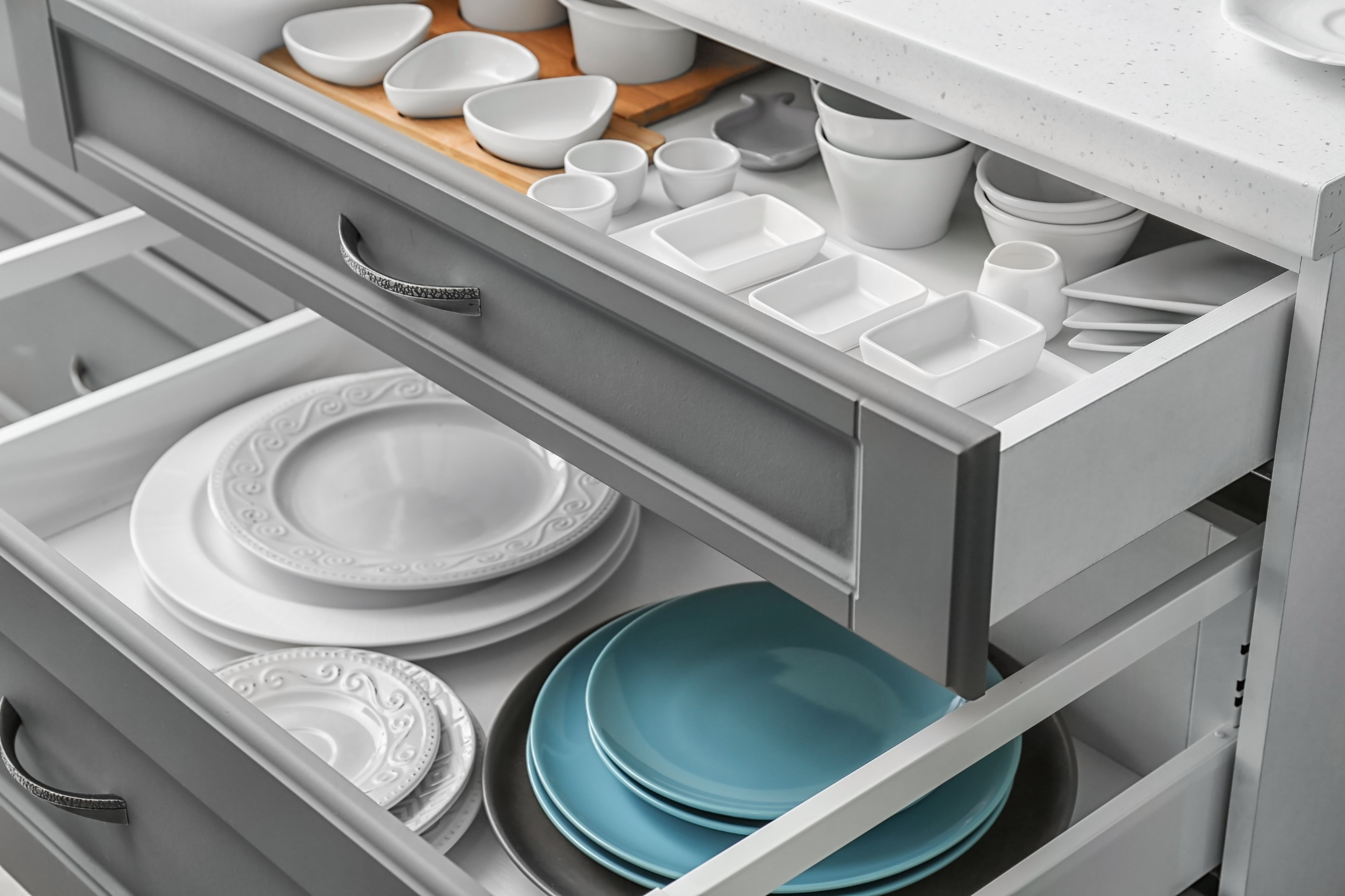 Set of tableware in kitchen drawers | Pierce Flooring