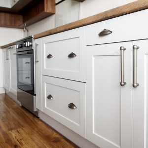 Stylish light gray handles on cabinets | Pierce Flooring