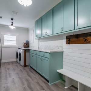Mint green and white laundry room with mudroom, counter space, oversized | Pierce Flooring
