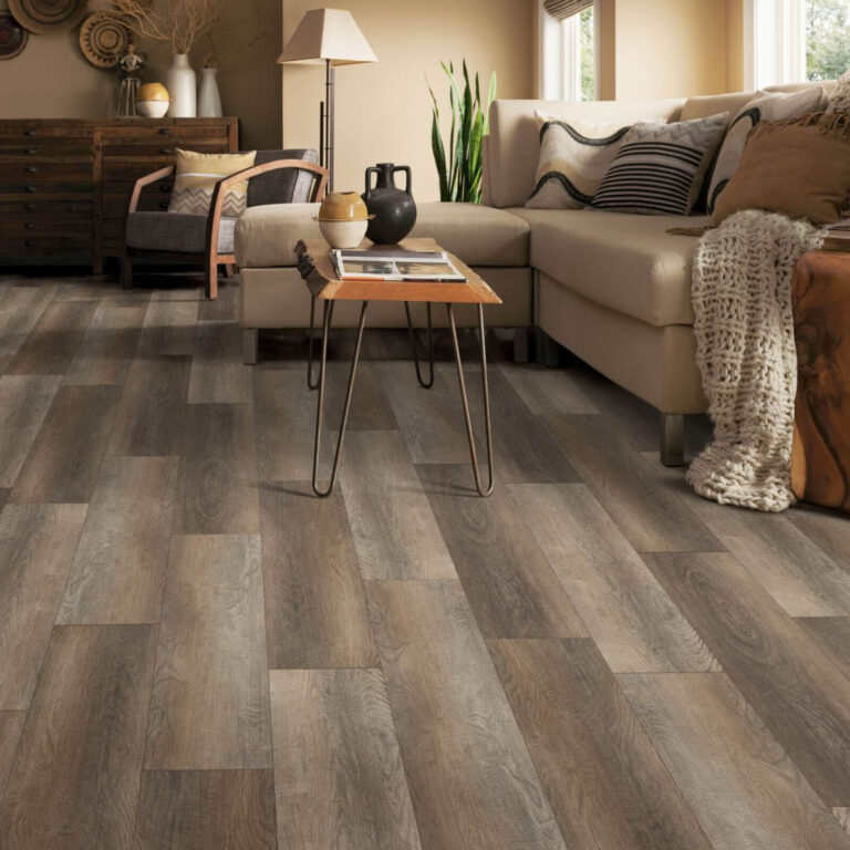 Cozy living room with a sectional sofa and coffee table on wide dark wood plank flooring.