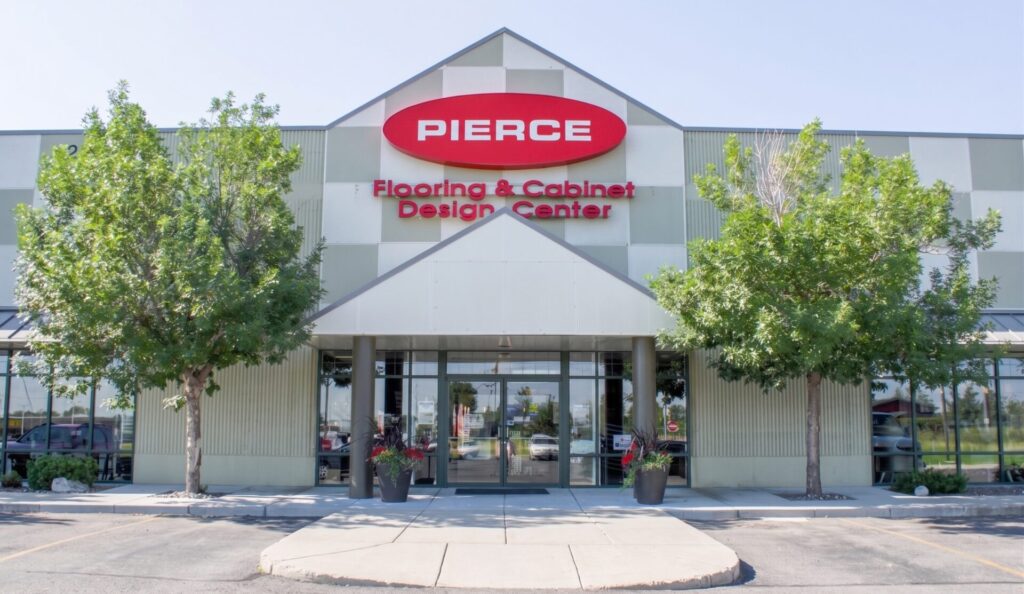 Pierce Flooring and Cabinet Design Center exterior on King Avenue West in Billings, Montana, with landscaped grounds and the Rimrocks in the distance.