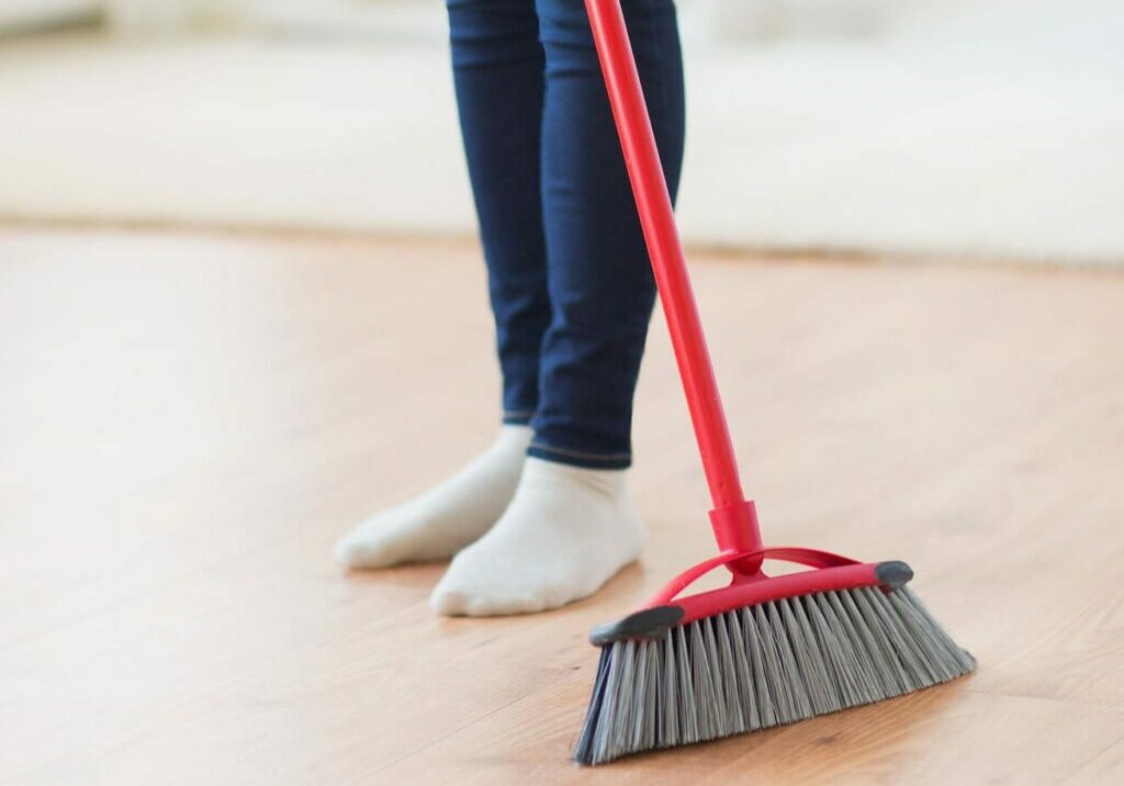 Lady with broom | Pierce Flooring